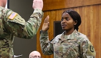 Juliana Nkafu takes the Oath of Office and commissions as a Illinois Army National Guard and U.S. Army second lieutenant during her April 26 commissioning ceremony.