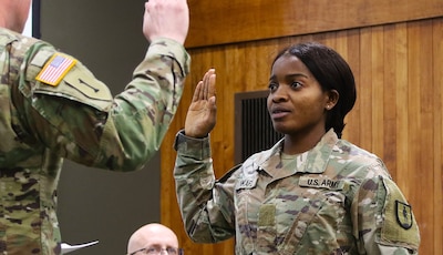 Juliana Nkafu takes the Oath of Office and commissions as a Illinois Army National Guard and U.S. Army second lieutenant during her April 26 commissioning ceremony.