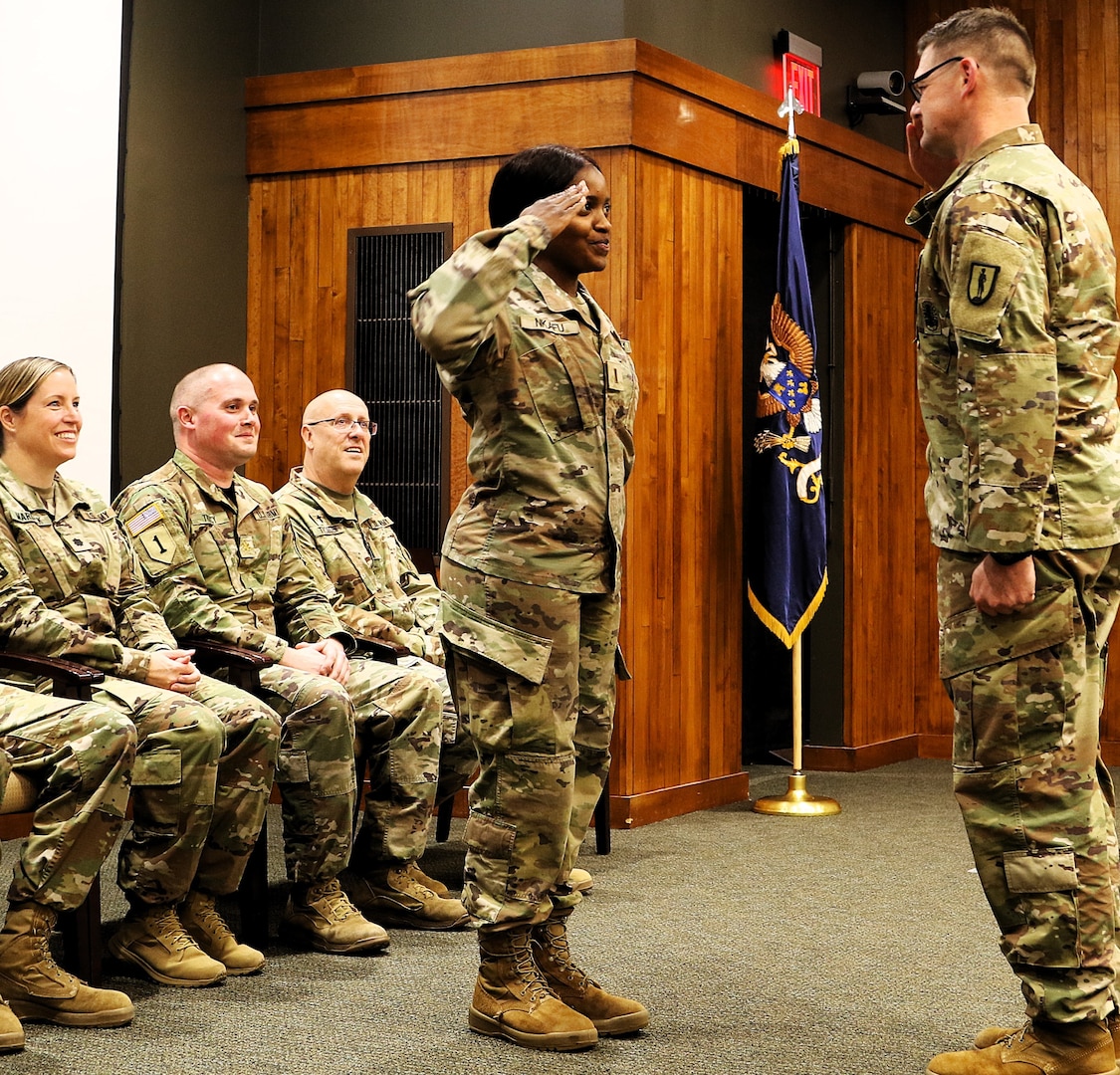 2nd Lt. Juliana Nkafu returns the salute of Sgt. 1st Class Paul Golladay as part of her commissioning ceremony.