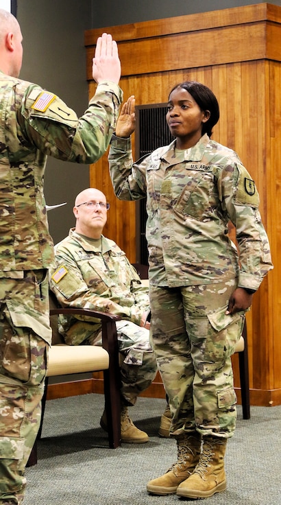 Juliana Nkafu takes the Oath of Office and commissions as a Illinois Army National Guard and U.S. Army second lieutenant during her April 26 commissioning ceremony.