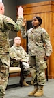 Juliana Nkafu takes the Oath of Office and commissions as a Illinois Army National Guard and U.S. Army second lieutenant during her April 26 commissioning ceremony.