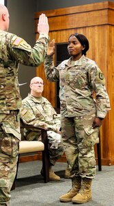 Juliana Nkafu takes the Oath of Office and commissions as a Illinois Army National Guard and U.S. Army second lieutenant during her April 26 commissioning ceremony.