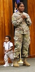 2nd Lt. Juliana Nkafu speaks to a group of officer candidates as her nephew, 13-month-old James Akemanji Nkengayi, also takes the stage at her commissioning ceremony.