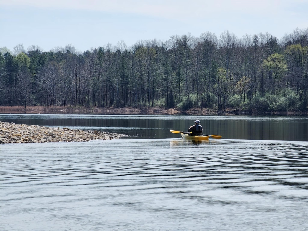 Ron Sergesketter, Patoka Lake volunteer, kayaks along the lake's shoreline to pick up trash and personal items that have washed up from recent flooding events April 7, 2025, Dubois, Indiana.