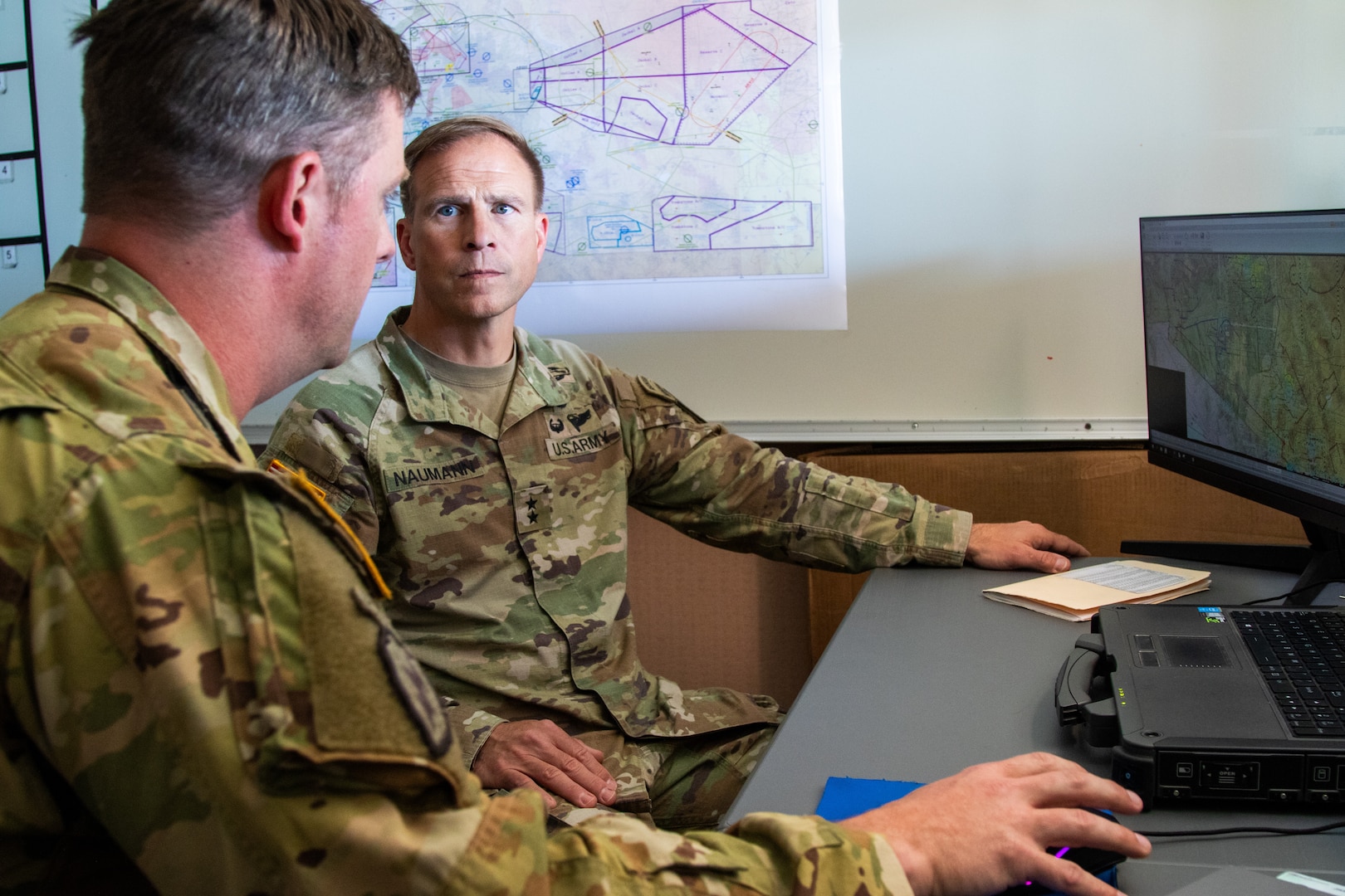 U.S. Army Soldiers sitting in front of computer.