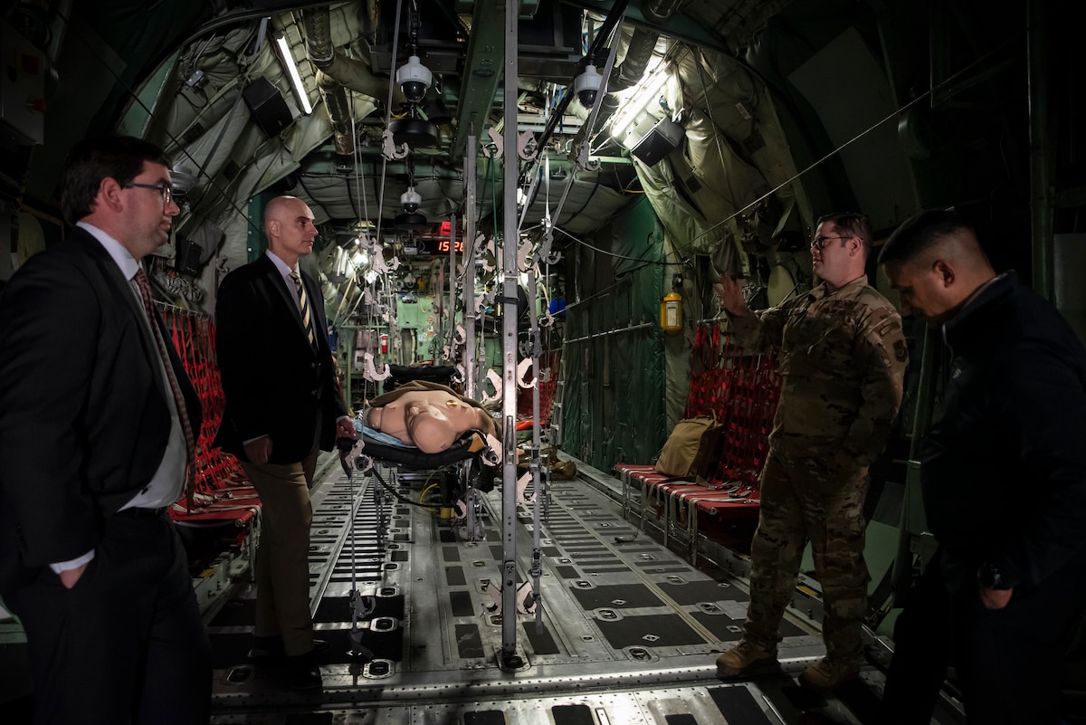 Leaders from Purdue University view a C-130 training aircraft, part of the En Route Care Training facility, during a tour at Wright-Patterson Air Force Base, Ohio, March 11, 2025. The U.S. Air Force School of Aerospace Medicine hosted Purdue leaders in honor of a new partnership that expands educational opportunities for Airmen and Guardians. (U.S. Air Force photo / Richard Eldridge)