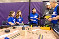 Volunteers provide instructions to a team of elementary students from Cottonwood Elementary School April 29, 2025, during the 3rd Annual Navy Peninsula Robotics Competition at North Kitsap High School in Poulsbo, Washington. (U.S. Navy photo by Jeb Fach)