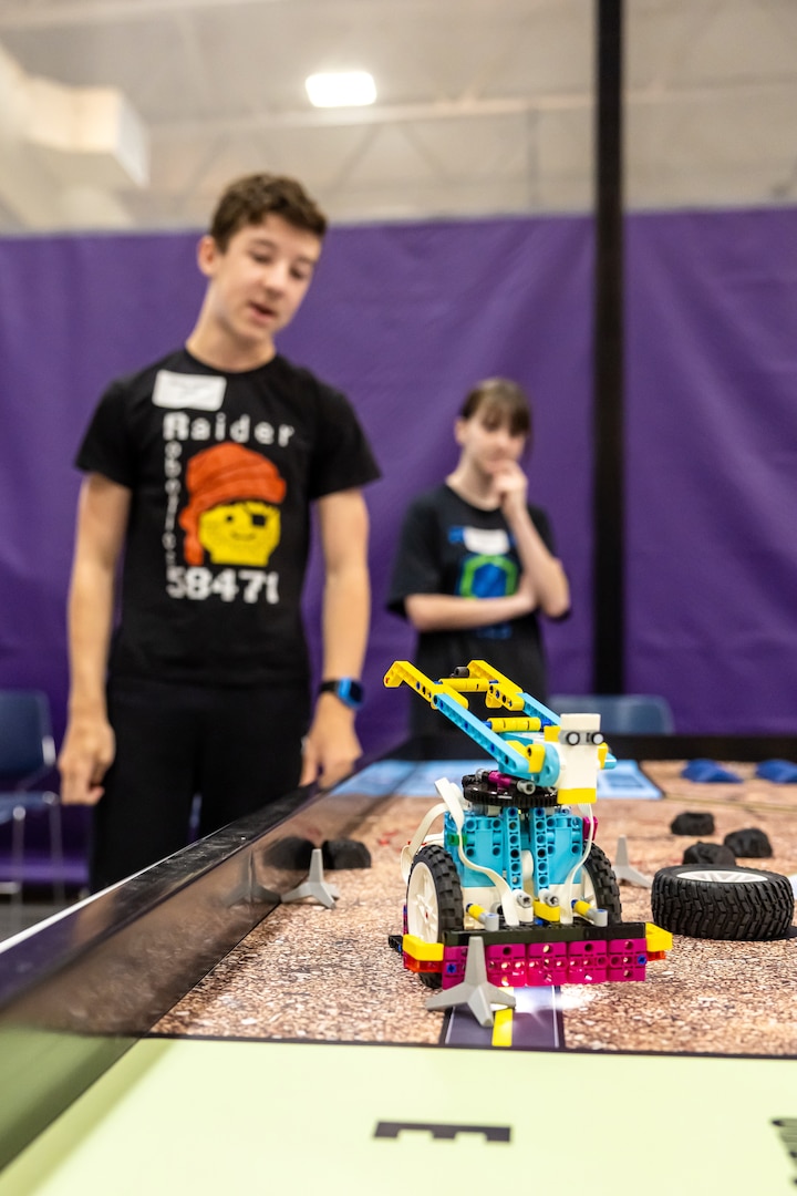 Teammates watch as their constructed robot navigates a challenge, April 29, 2025, during the 3rd Annual Navy Peninsula Robotics Competition at North Kitsap High School in Poulsbo, Washington. (U.S. Navy photo by Jeb Fach)