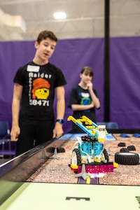 Teammates watch as their constructed robot navigates a challenge, April 29, 2025, during the 3rd Annual Navy Peninsula Robotics Competition at North Kitsap High School in Poulsbo, Washington. (U.S. Navy photo by Jeb Fach)