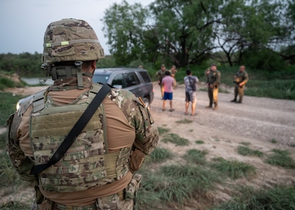 A U.S. Soldier with the Texas Army National Guard watches as U.S. Border Patrol agents conduct a traffic stop near the Rio Grande during a patrol near Roma, Texas, April 23, 2025.
