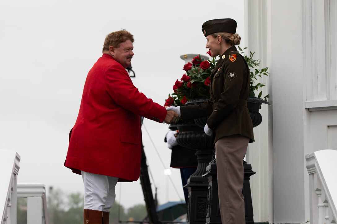 Steve Buttleman, the Churchill Downs Bugler, introduces himself to Spc. Natalie Mercado at the Pagoda during the 151st running of the Kentucky Derby at Churchill Downs in Louisville, Kentucky, May 3, 2025. Buttleman has been the official Bugler at Churchill Downs for thirty years and always stops to thank the Trophy Guard for their service. (U.S. Army National Guard photo by Sgt. Caleb Sooter)