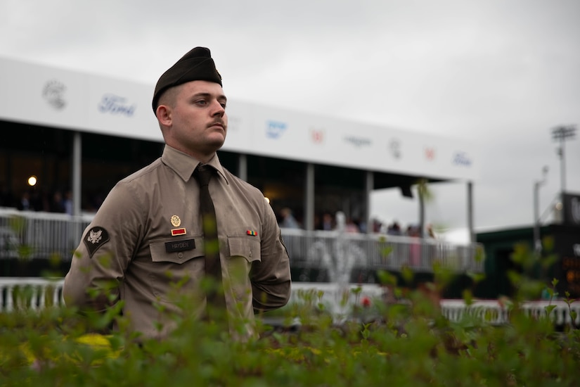 Spc. Ryan Hayden of the 438th Military Police Company renders honors during a race during the 151st running of the Kentucky Derby at Churchill Downs in Louisville, Kentucky, May 3, 2025. Service members from almost every branch were present during the Derby to post near the finish line. (U.S. Army National Guard photo by Sgt. Caleb Sooter)