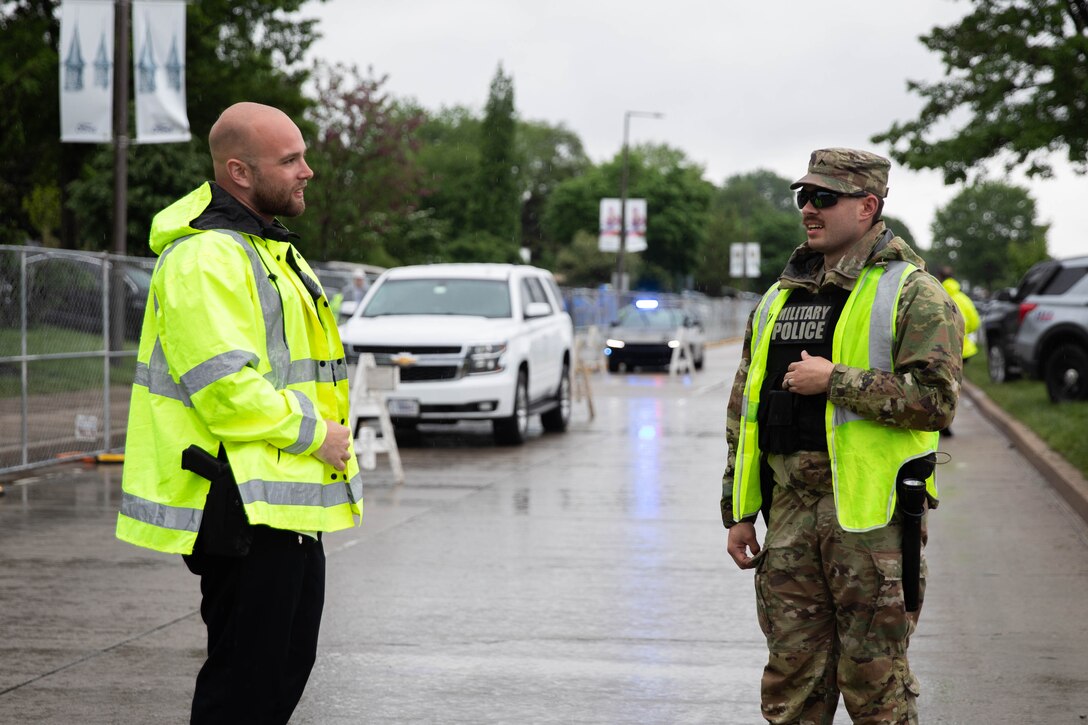 Soldiers of the 438th Military Police Company assist traffic direction alongside Louisville Metro Police Department (LMPD) officers during the 151st running of the Kentucky Derby at Churchill Downs in Louisville, Kentucky, May 3, 2025. The 438th set up over 20 traffic control points with LMPD around Churchill Downs to ensure a smooth flow of visitors while minimally disrupting local traffic. (U.S. Army National Guard photo by Sgt. Caleb Sooter)