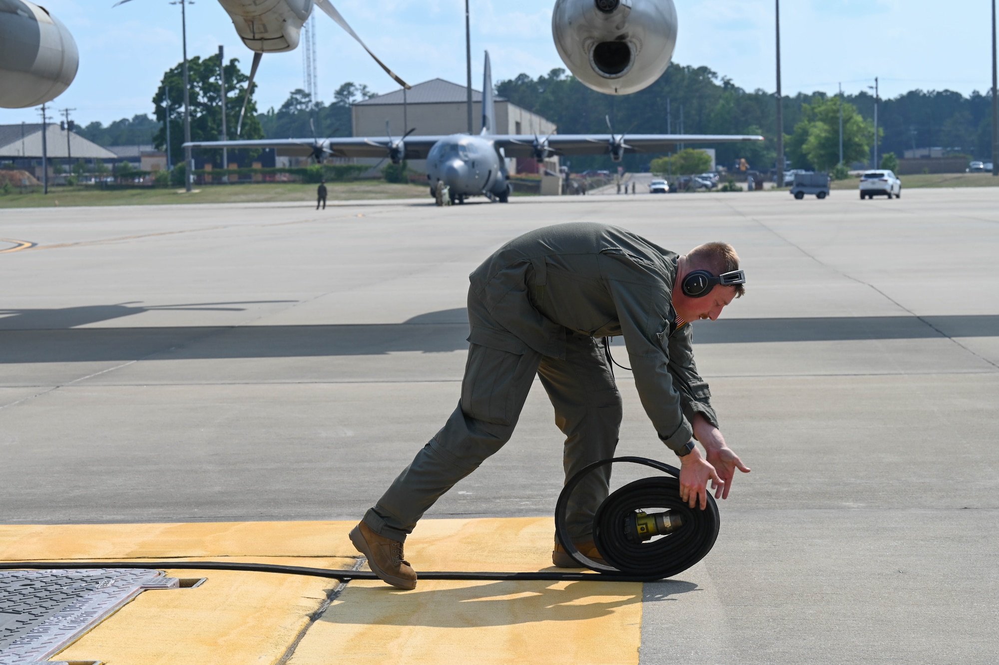 A Marine unrolls a hose.