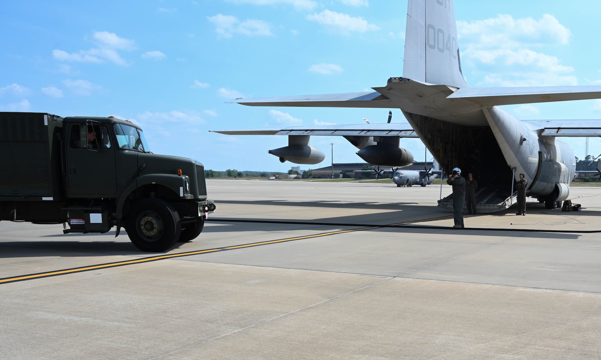 A fuel truck marshalls to an aircraft.