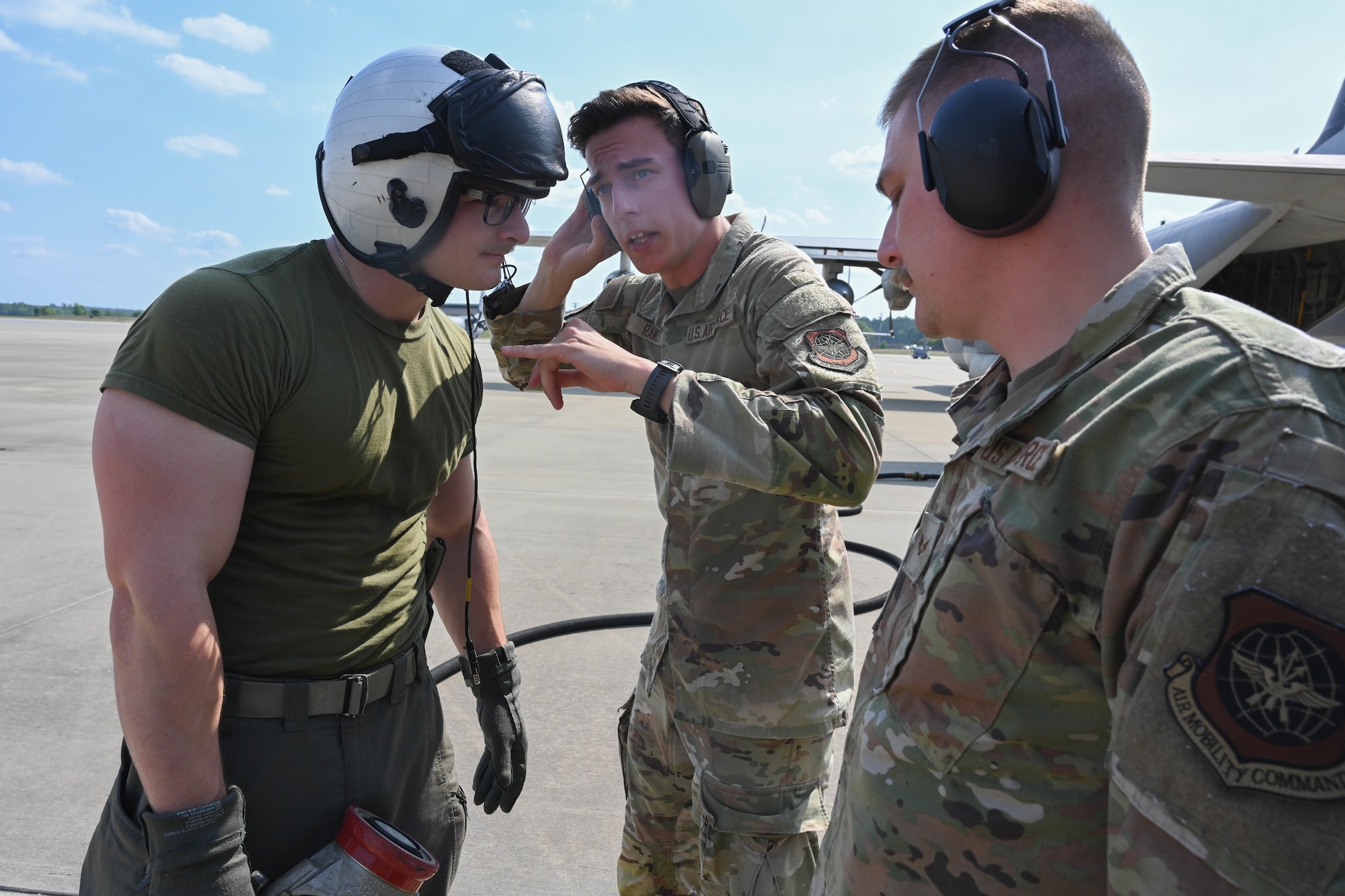 An Airman and Marine speak to each other.