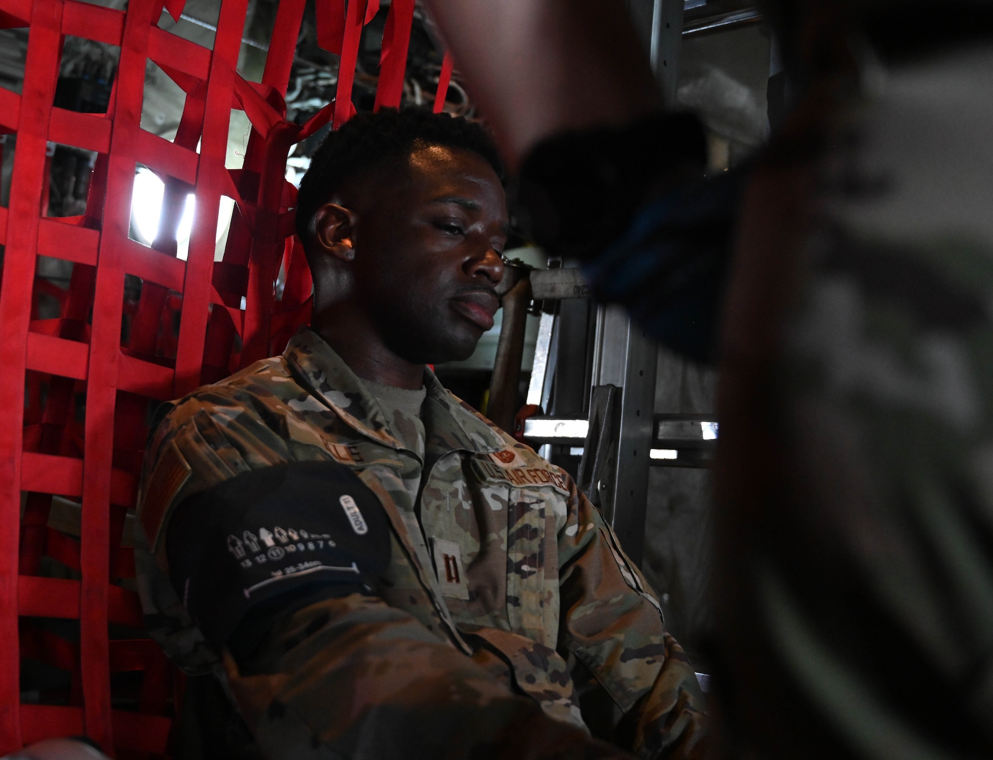 An Airman sits while wearing medical equipment.