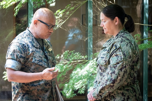 Commander Stacey Swindells, right, a Nurse serving aboard Naval Health Clinic Cherry Point, prays with Navy Chaplain Commander Philip Park during a Blessing of the Hands ceremony Wednesday, May 7. The spiritual fitness event honored the compassion and professionalism of the nursing staff serving in the facility while fortifying their spiritual resolve.