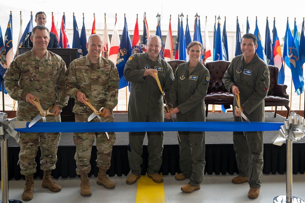 Air Force leaders cut a ribbon during a ceremony.