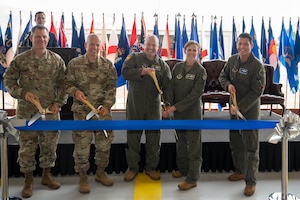 Air Force leaders cut a ribbon during a ceremony.
