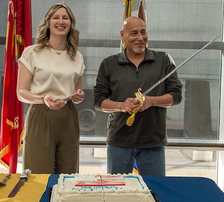Making the cut ...Veronica Caraballo, regional exceptional family member program coordinator (L) and Frank Sandoval, material management handler, wield honors in handling the traditional cake cutting portion of Naval Hospital Bremerton's Civilian Corps 8th Anniversary commemoration held May 6, 2025. “Our civilian personnel have long served as the steady foundation of Navy Medicine. You are the continuity that keeps our mission moving forward, providing unwavering support, deep institutional knowledge, and steadfast commitment to both operational readiness and patient care.  Across Navy Medicine, approximately 2,000 civilians serve in a wide range of critical roles. While many now fall under the Defense Health Agency, we remain proud of all of our civilian workforce,” stated Capt. Karla Lepore, Naval Hospital Bremerton director and Navy Medicine Readiness Training Command Bremerton commanding officer (Official Navy photo by Mass Communication Specialist 2nd Class Jennifer Benedict).