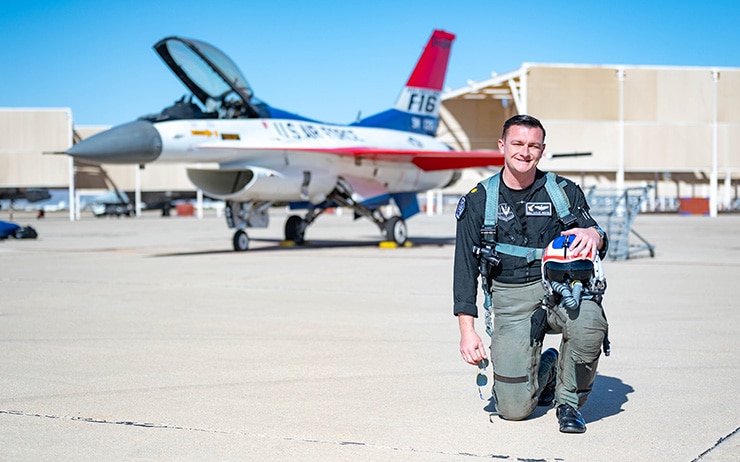 A photo of a pilot in front of an F-16 Fighting Falcon.