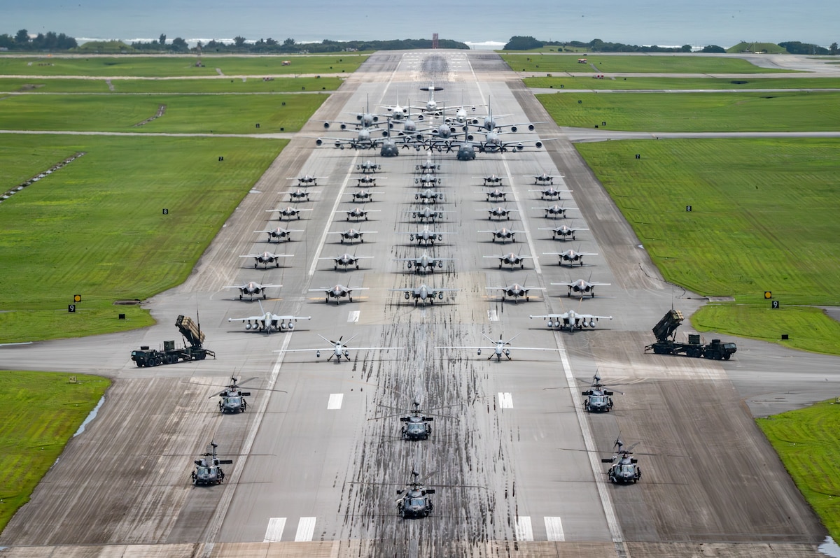 U.S. Air Force, Navy and Army assets line the runway for an elephant walk.