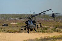 A U.S. AH-64 Apache fires missiles at targets during a training mission at Camp Ādaži, Latvia, May 02, 2025. Four AH-64 Apaches from the Combat Aviation Brigade, 1st Armored Division,  flew to a training area at Camp Adazi to demonstrate the aircraft’s precision and lethality to distinguished guests attending the training event. The U.S. remains committed to the NATO alliance and our Latvian allies. Latvia’s investment in its defense and cooperation with the U.S. strengthens deterrence and security along NATO’s eastern flank. (U.S. Army photo by Staff Sgt. Rose Di Trolio)