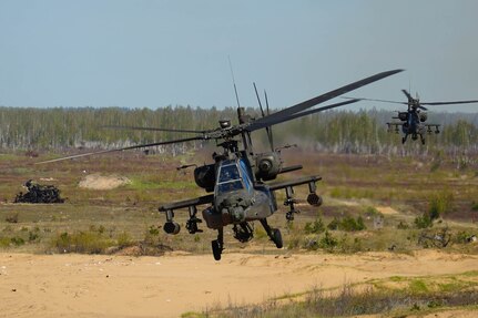 A U.S. AH-64 Apache fires missiles at targets during a training mission at Camp Ādaži, Latvia, May 02, 2025. Four AH-64 Apaches from the Combat Aviation Brigade, 1st Armored Division,  flew to a training area at Camp Adazi to demonstrate the aircraft’s precision and lethality to distinguished guests attending the training event. The U.S. remains committed to the NATO alliance and our Latvian allies. Latvia’s investment in its defense and cooperation with the U.S. strengthens deterrence and security along NATO’s eastern flank. (U.S. Army photo by Staff Sgt. Rose Di Trolio)