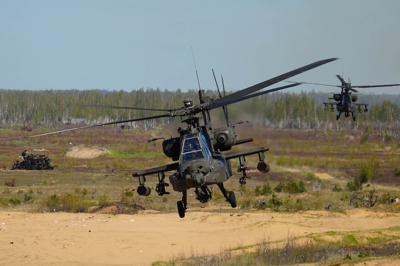 A U.S. AH-64 Apache fires missiles at targets during a training mission at Camp Ādaži, Latvia, May 02, 2025. Four AH-64 Apaches from the Combat Aviation Brigade, 1st Armored Division,  flew to a training area at Camp Adazi to demonstrate the aircraft’s precision and lethality to distinguished guests attending the training event. The U.S. remains committed to the NATO alliance and our Latvian allies. Latvia’s investment in its defense and cooperation with the U.S. strengthens deterrence and security along NATO’s eastern flank. (U.S. Army photo by Staff Sgt. Rose Di Trolio)