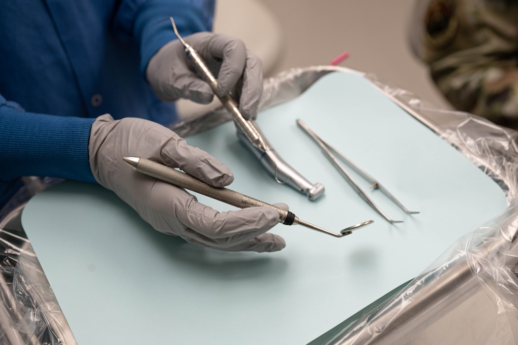 U.S. Air Force 2nd Lt. Sarah Ellis, student doctor at Midwestern University, picks up her instruments while preparing to treat her patient, May 2, 2025, at Luke Air Force Base, Arizona.