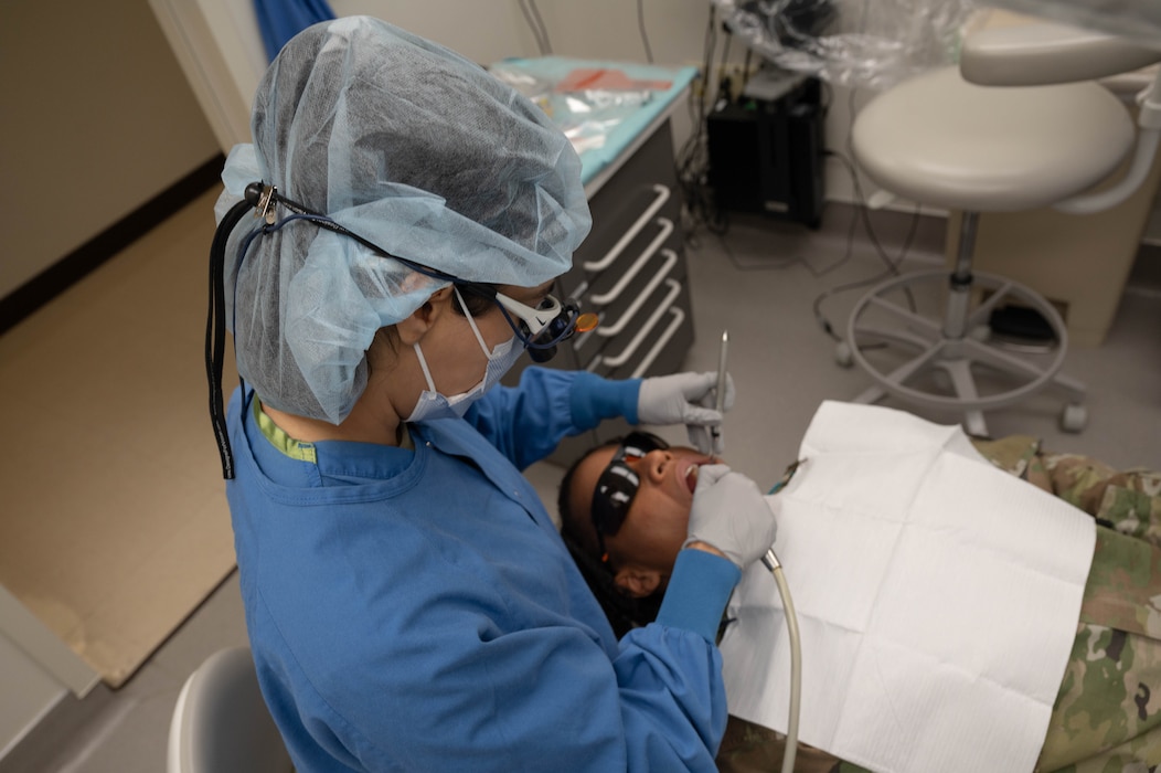 U.S. Air Force 2nd Lt. Sarah Ellis, student doctor at Midwestern University, examines her patient's teeth, May 2, 2025, at Luke Air Force Base, Arizona.