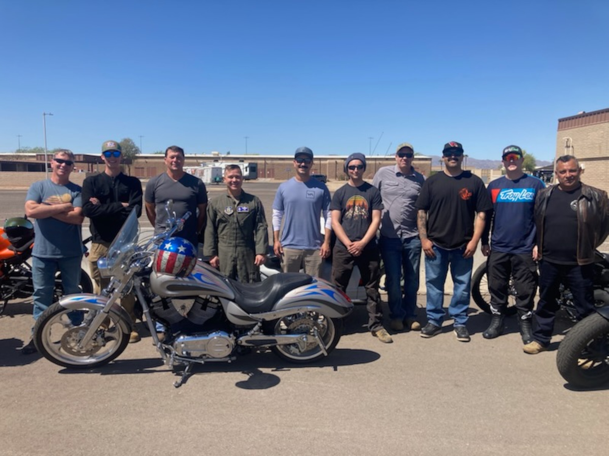 Participants of the 944th  Fighter Wing Annual Spring Mentorship Ride pose for a photo with this years' lead, Col Todd Riddle 944th FW commander, at Luke Air Force Base, Ariz., April 2025. The Motorcycle Safety Representatives, assist members with a preseason Tires, Controls, Lights, Oil, Chassis, and Stands, inspection, helping to ensure rider safety and meet their Level lll class requirements.(U.S. Air Force Courtesy Photo)