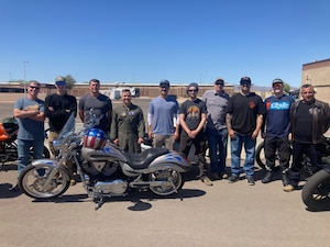 Participants of the 944th  Fighter Wing Annual Spring Mentorship Ride pose for a photo with this years' lead, Col Todd Riddle 944th FW commander, at Luke Air Force Base, Ariz., April 2025. The Motorcycle Safety Representatives, assist members with a preseason Tires, Controls, Lights, Oil, Chassis, and Stands, inspection, helping to ensure rider safety and meet their Level lll class requirements.(U.S. Air Force Courtesy Photo)