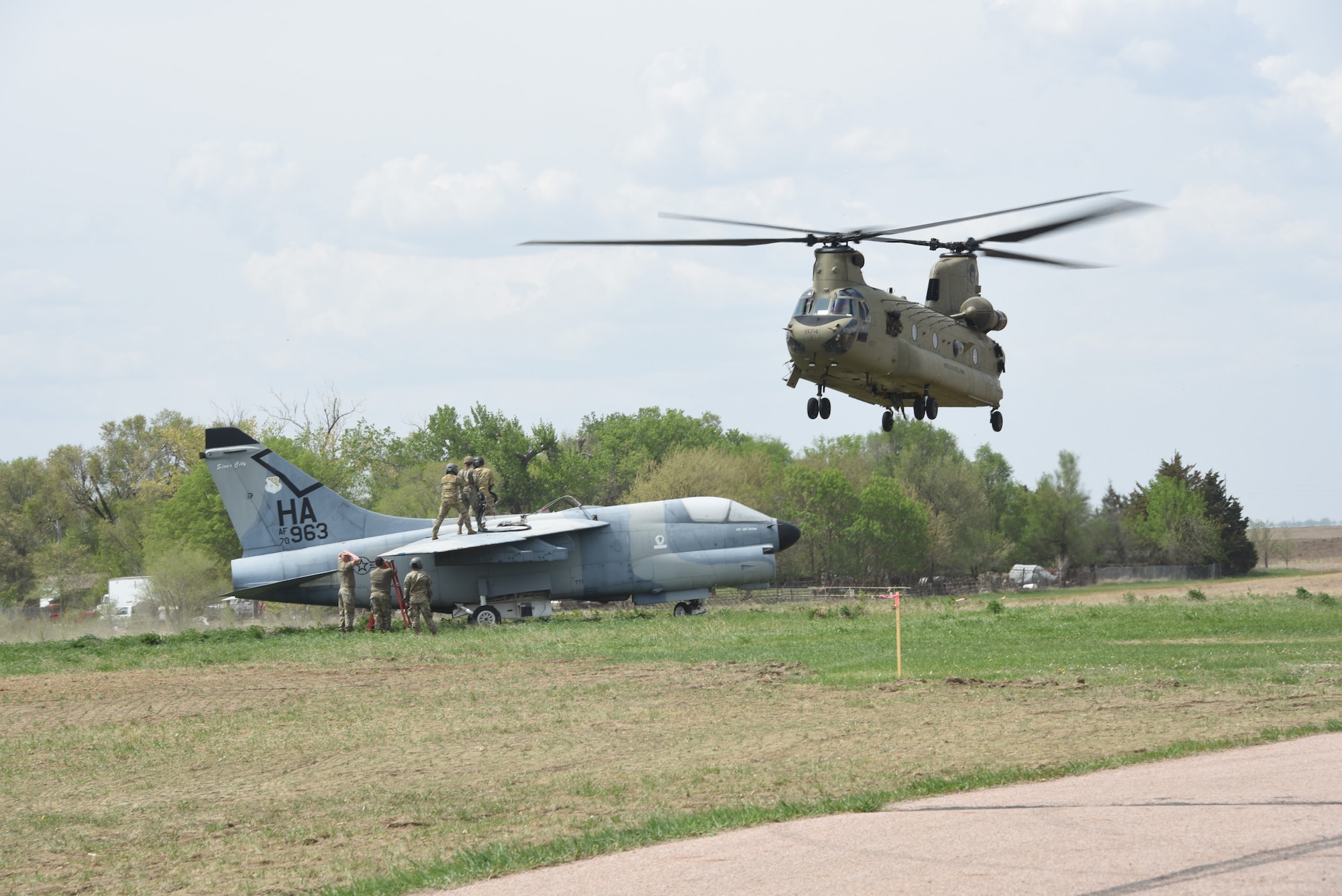 185th Air Refueling Wing Airmen and Soldiers assigned to Bravo Company 1st Battalion 171st Aviation Regiment in Davenport, IA transferred an A-7 Corsair Static display from Martin Field, South Sioux City, NE to Sioux City, IA’s 185th ARW paint facility with a CH-47 Chinook helicopter on May 7, 2025.