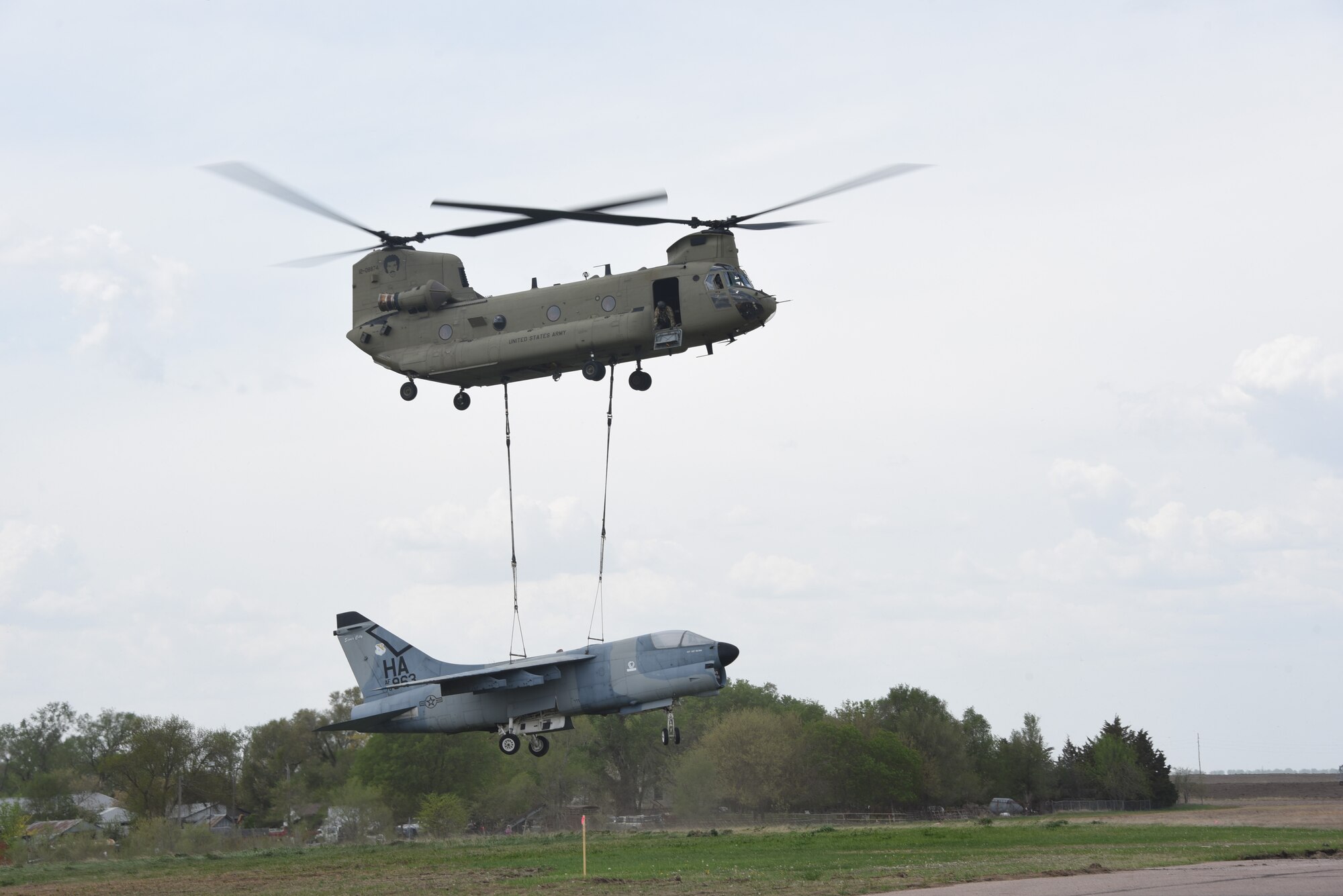 185th Air Refueling Wing Airmen and Soldiers assigned to Bravo Company 1st Battalion 171st Aviation Regiment in Davenport, IA transferred an A-7 Corsair Static display from Martin Field, South Sioux City, NE to Sioux City, IA’s 185th ARW paint facility with a CH-47 Chinook helicopter on May 7, 2025.
