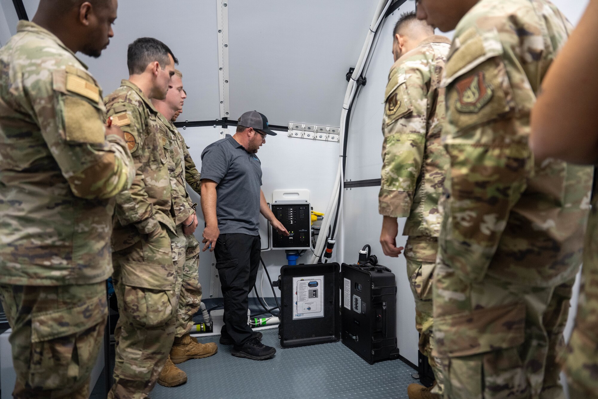 Airmen receiving brief from a contractor.