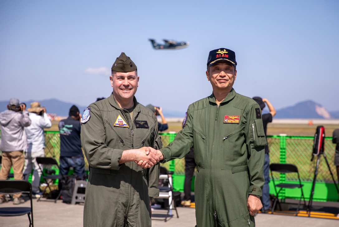 U.S. Marine Corps Col. Richard Rusnok, left, the commanding officer of Marine Corps Air Station Iwakuni, and a Pennsylvania native, and Japan Maritime Self-Defense Force Rear Adm. Ichiro Ishikawa, right, the commander of Fleet Air Wing 31, pose for photo during the Japan Maritime Self-Defense Force-Marine Corps Air Station Iwakuni Friendship Day at MCAS Iwakuni, Japan, May 4, 2025. The JMSDF-MCAS Iwakuni Friendship Day is hosted annually to strengthen relationships with the host community and offer a cultural exchange that highlights the mutual support between the U.S. and Japan. (U.S. Marine Corps photo by SSgt. Jennessa Davey)