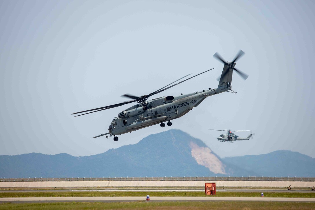 A U.S. Marine Corps CH-53E Super Stallion with Marine Heavy Helicopter Squadron (HMH) 462 and a UH-1Y Venom with Light Attack Helicopter Squadron (HMLA) 169, both currently assigned to Marine Aircraft Group 36, 1st Marine Aircraft Wing, conduct a flight demonstration during Family Day at Marine Corps Air Station Iwakuni, Japan, May 3, 2025. Family Day allowed both U.S. and Japanese members of the MCAS Iwakuni community, their family members, local orphanages, and members of the local community with special needs the ability to experience a small-scale Friendship Day during the air show rehearsal, which showcased the strength of the U.S.-Japan Alliance. ​ (U.S. Marine Corps photo by LCpl. Rylan Adcock)