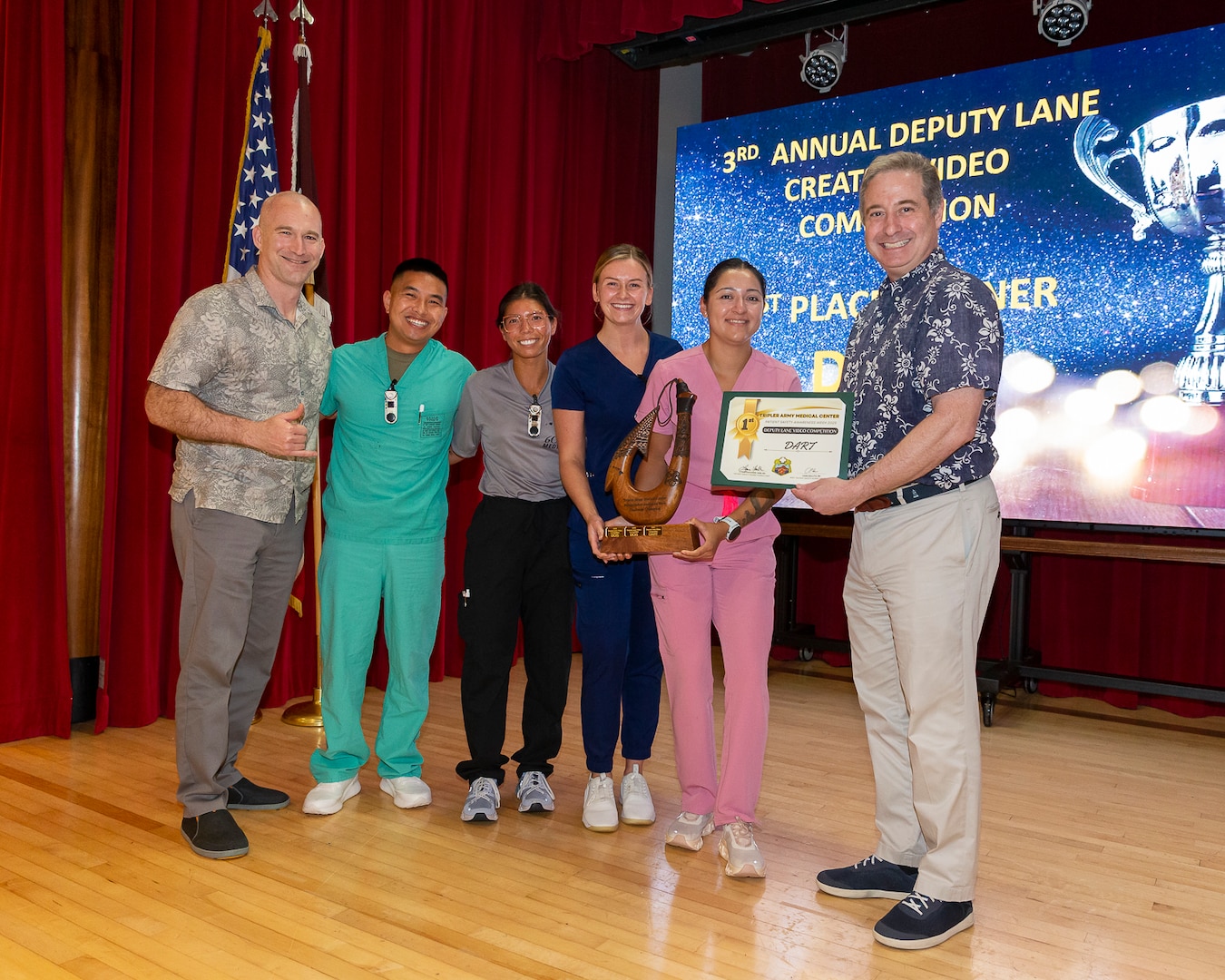 Tripler Army Medical Center’s Clinical Nurse Transition Program wins first place for their video presentation for the Deputy Lane Video Competition during Patient Safety Awareness Week held in Kyser Auditorium on Mar. 14, 2025. U.S. Army Col. Mitch Hamele, director of TAMC’s Directorate of Academics, Research and Training stand with 2nd Lt. Joseph Lynch, 2nd Lt.  Rochelle Koepke, 2nd Lt.  Ashlynn Kinter, 2nd Lt. Wendy Moreno, and Dr. Sean Harap, Deputy Commander of Quality and Safety. (Defense Health Agency photo by Crizalmer Caraang Jr.)