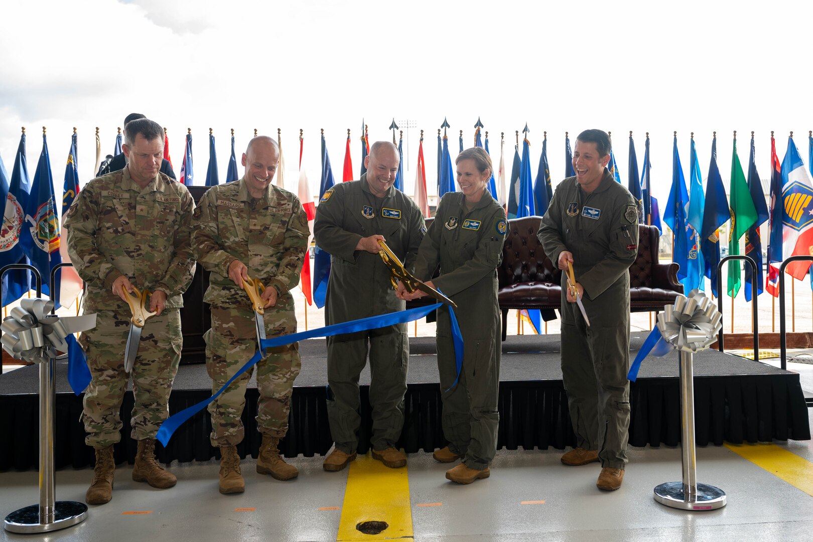 Air Force leaders cut a ribbon during a ceremony.