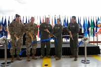 Air Force leaders cut a ribbon during a ceremony.