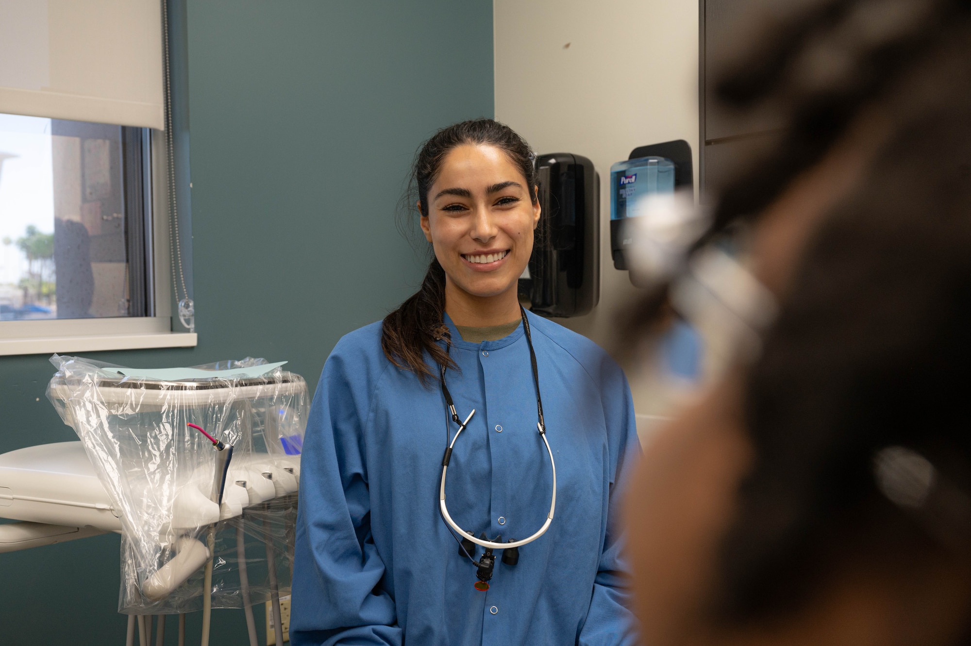 U.S. Air Force 2nd Lt. Sarah Ellis, student doctor at Midwestern University, greets her patient, May 2, 2025, at Luke Air Force Base, Arizona.