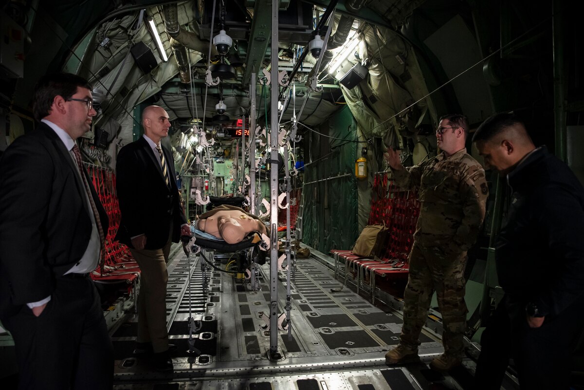 Leaders from Purdue University view a C-130 training aircraft, part of the En Route Care Training facility, during a tour at Wright-Patterson Air Force Base, Ohio, March 11, 2025. The U.S. Air Force School of Aerospace Medicine hosted Purdue leaders in honor of a new partnership that expands educational opportunities for Airmen and Guardians. (U.S. Air Force photo / Richard Eldridge)