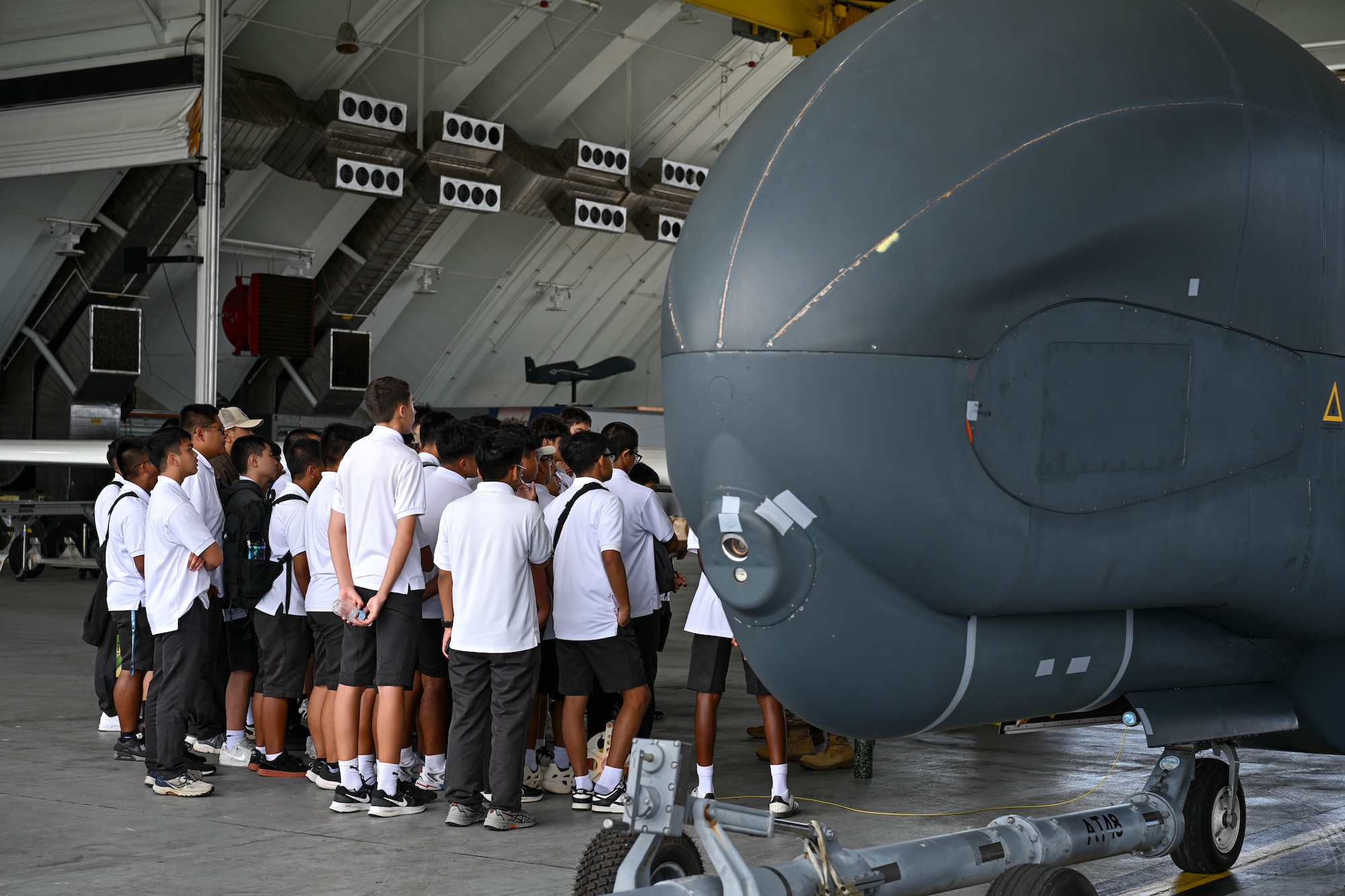 George Washington High School pre-engineering students and Father Duenas Memorial School Junior Reserve Officers’ Training Corps students tour Andersen Air Force Base, Guam, May 2, 2025. HSC-25 members showcased the MH-60S Sea Hawk while explaining day to day life as pilots, rescue swimmers, maintenance and more as part of a base tour. (U.S. Air Force photo by Senior Airman Audree Campbell)