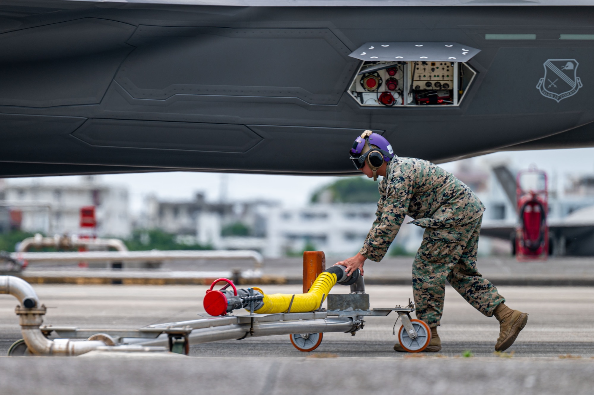 A U.S. Marine Corps bulk fuel specialists assigned to the 1st Marine Aircraft Wing removes a fuel hose from a U.S. Air Force F-35A Lightning II after a hot-pit refueling at Marine Corps Air Station Futenma, Japan during a routine 18th Wing readiness exercise at Kadena Air Base, Japan, May 6, 2025.