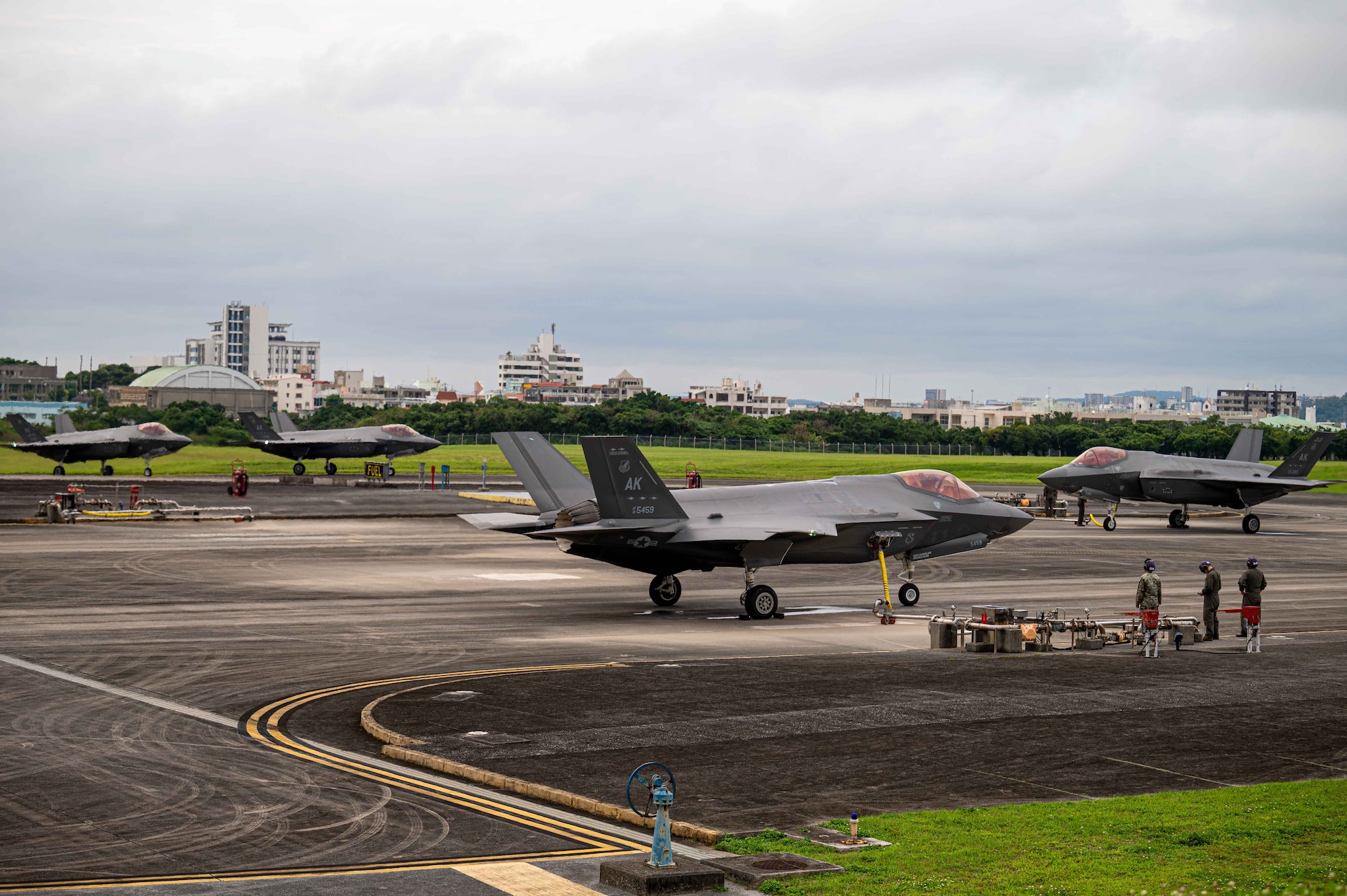 U.S. Marine Corps bulk fuel specialists assigned to the 1st Marine Aircraft Wing preform hot-pit refueling on F-35A Lightning IIs assigned to the 355th Expeditionary Fighter Squadron at Marine Corps Air Station Futenma, Japan during a routine 18th Wing readiness exercise at Kadena Air Base, Japan, May 6, 2025.