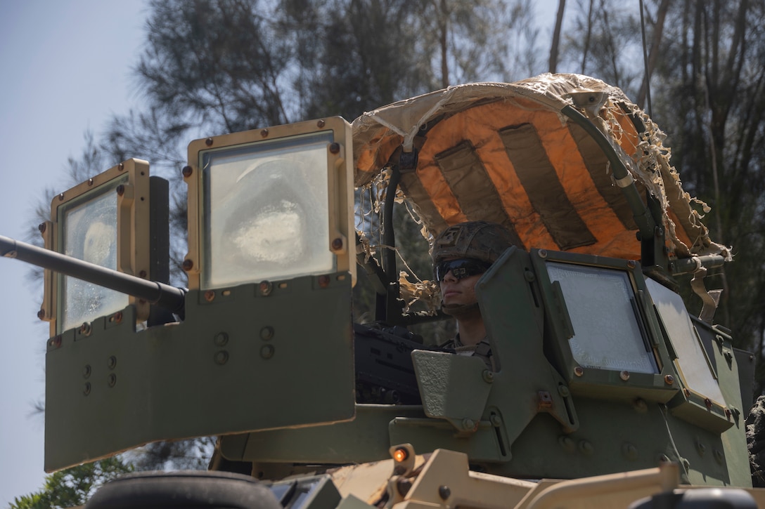 U.S. Marine Corps Cpl. Christian MirandaSanatana, a motor vehicle operator with Combat Logistics Battalion 31, 31st Marine Expeditionary Unit, posts security inside a Joint Light Tactical Vehicle during a combat service support area exercise as part as MEU Exercise on Camp Hansen, Okinawa, Japan, May 3, 2025. Marines with the CLB-Alpha Company participated in an exercise to enhance interoperability and strengthen ship-to-shore capabilities. The 31st MEU, the Marine Corps’ only continuously forward deployed MEU, provides a flexible and lethal force, ready to perform a wide range of military operations as the premiere crisis response force in the Indo-Pacific region. MirandaSanatana is a native of California. (U.S. Marine Corps photo by Lance Cpl. Skilah Sanchez)