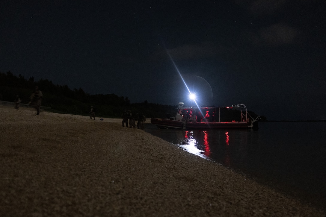 U.S. Marines with Maritime Raid Force, 31st Marine Expeditionary Unit, secure the beach during reconnaissance beach survey training as part of MEU Exercise at Kin Blue Beach Training Area, Okinawa, Japan, May 6, 2025. The Marines conducted the training to ensure dive proficiency and further enhance amphibious reconnaissance skills by utilizing JaiaBot unmanned underwater vehicles to locate the optimal crossing point in the water enabling rapid and safe crossing. The 31st MEU, the Marine Corps’ only continuously forward-deployed MEU, provides a flexible and lethal force ready to perform a wide range of military operations as the premiere crisis response force in the Indo-Pacific region. (U.S. Marine Corps photo by Cpl. Alora Finigan)