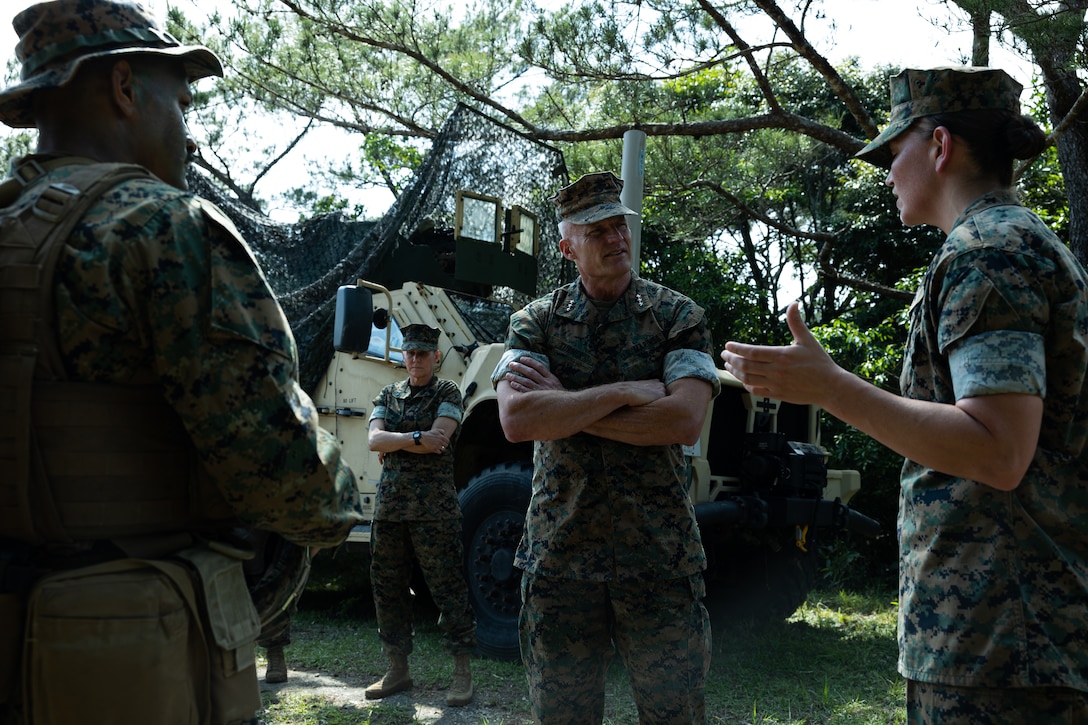 U.S. Marine Corps Capt. Marcus Holeman Jr, left, and Lt. Col. Alyssa Taursik, right, leaders with Combat Logistics Battalion 31, 31st Marine Expeditionary Unit, speak with Lt. Gen. Roger Turner, commanding general of III Marine Expeditionary Force, center, during a commanding general visit at Camp Hansen, Okinawa, Japan, May 6, 2025. Turner visited Marines with the 31st MEU in order to give recognition for various accomplishments. The 31st MEU, the Marine Corps’ only continuously forward-deployed MEU, provides a flexible and lethal force ready to perform a wide range of military operations as the premiere crisis response force in the Indo-Pacific region. (U.S. Marine Corps photo by Lance Cpl. Raul Sotovilla)